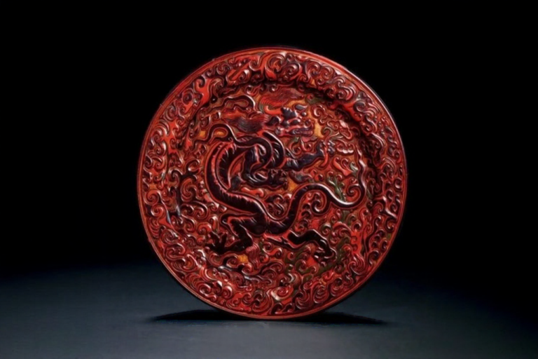 Ming Dynasty carved red round plate with cloud and dragon pattern